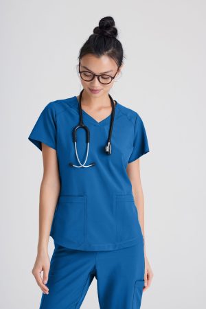 Grey's Anatomy Evolve 2 Pocket Piped V-Neck Top in Blue