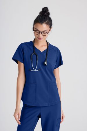 Grey's Anatomy Evolve 2 Pocket Piped V-Neck Top in Indigo